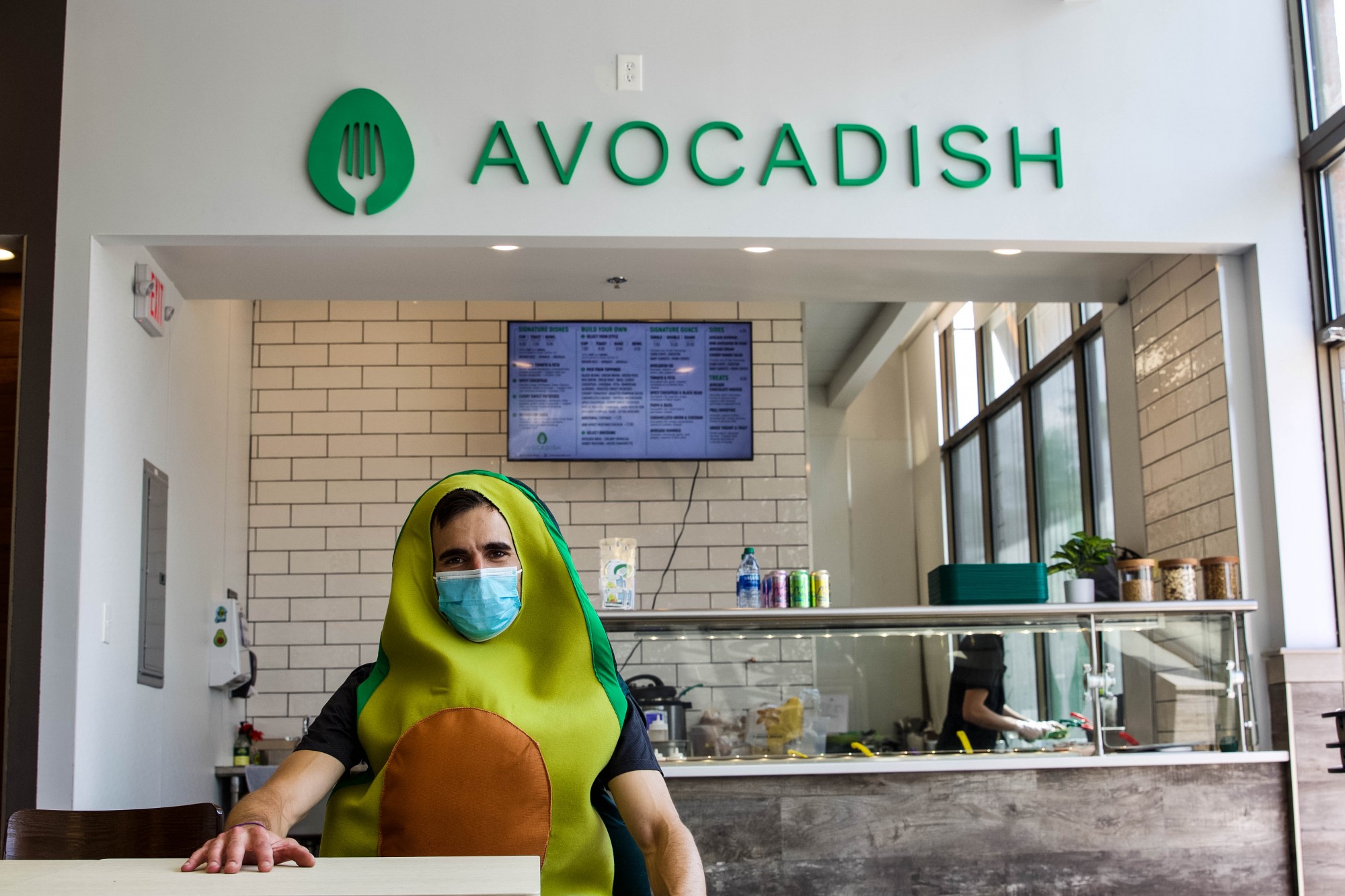 Alex Varouhas, owner of new Dinkytown restaurant, Avocadish, sports an avocado costume while posing for a portrait on Tuesday, June 30. Avocadish opened June 25 and is located in the University Food Hall.
