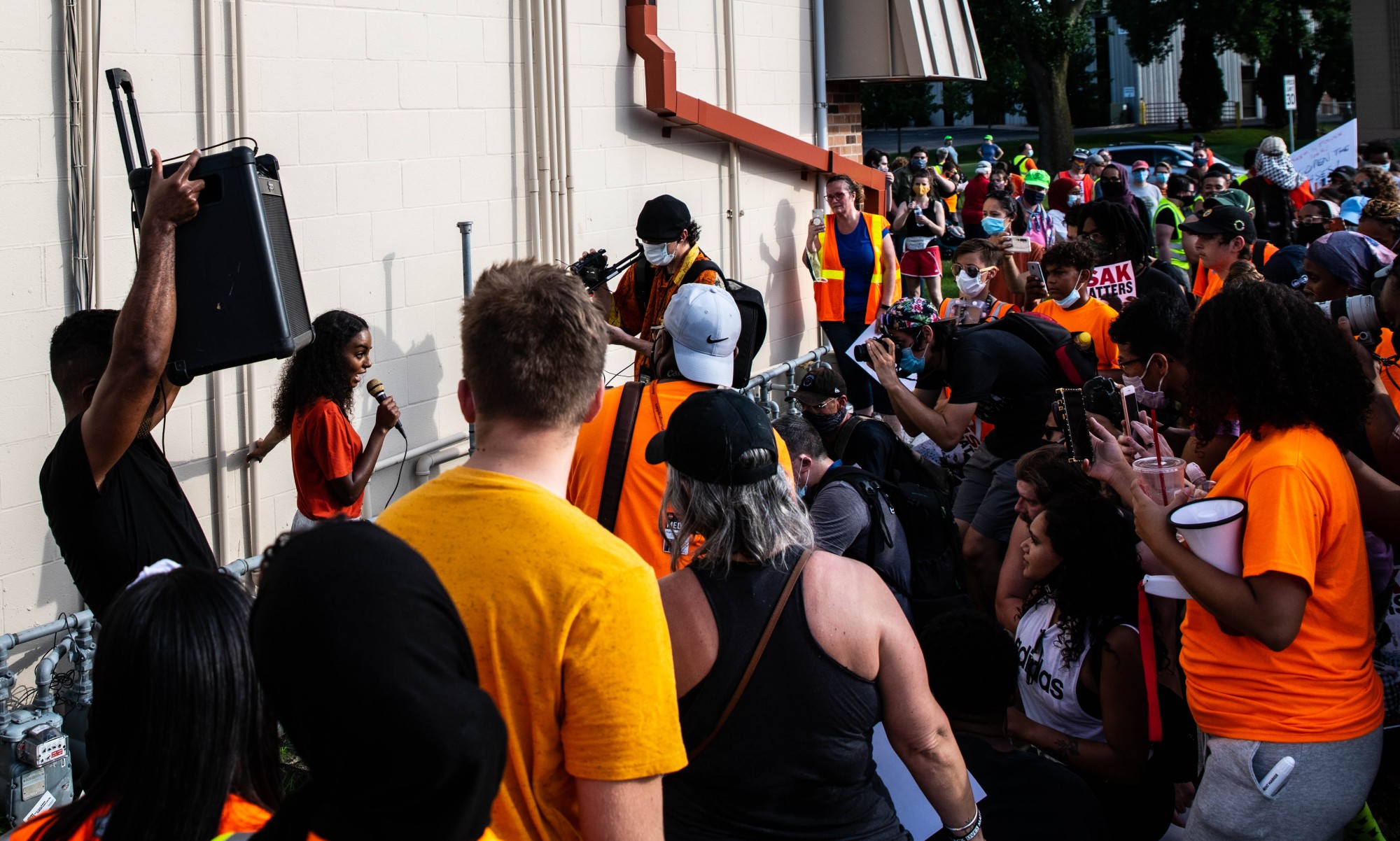 Sumaya Aden, Isak Aden’s sister, addresses protesters in a parking lot near Twin Cities Premium Outlets, the site where police killed 23-year-old Isak Aden in July of 2019 in Eagan on Wednesday, July 1.  