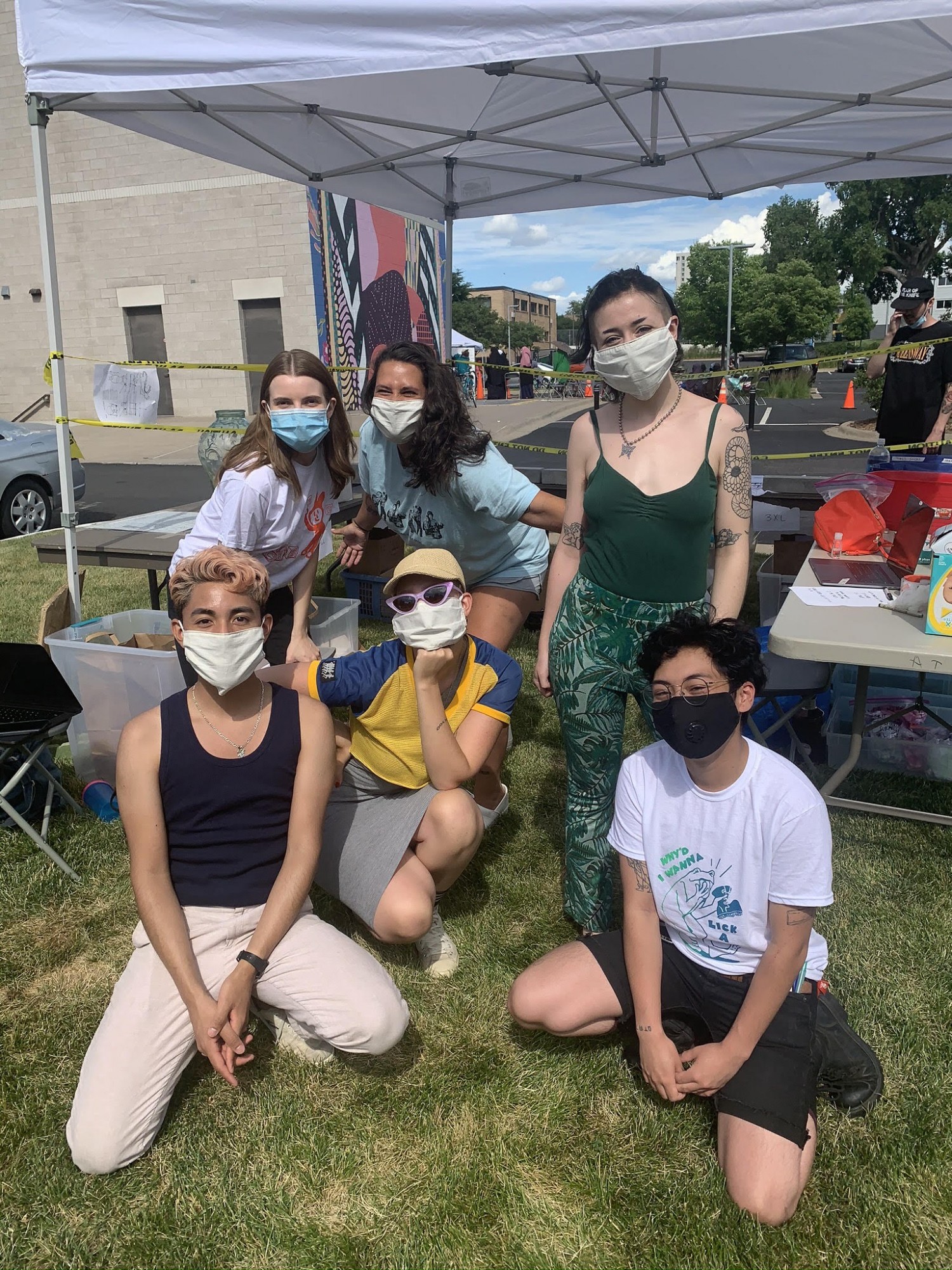 Ursula Arhart, Kristina Johnson, Cecily Bohman, Jaime Candia, Rebekah Nygard, and Nico Sardina,  from back left to front right, pose for a picture while working at the Peoples Library T-Shirt pop-up shop. (Photo courtesy of The People’s Library)