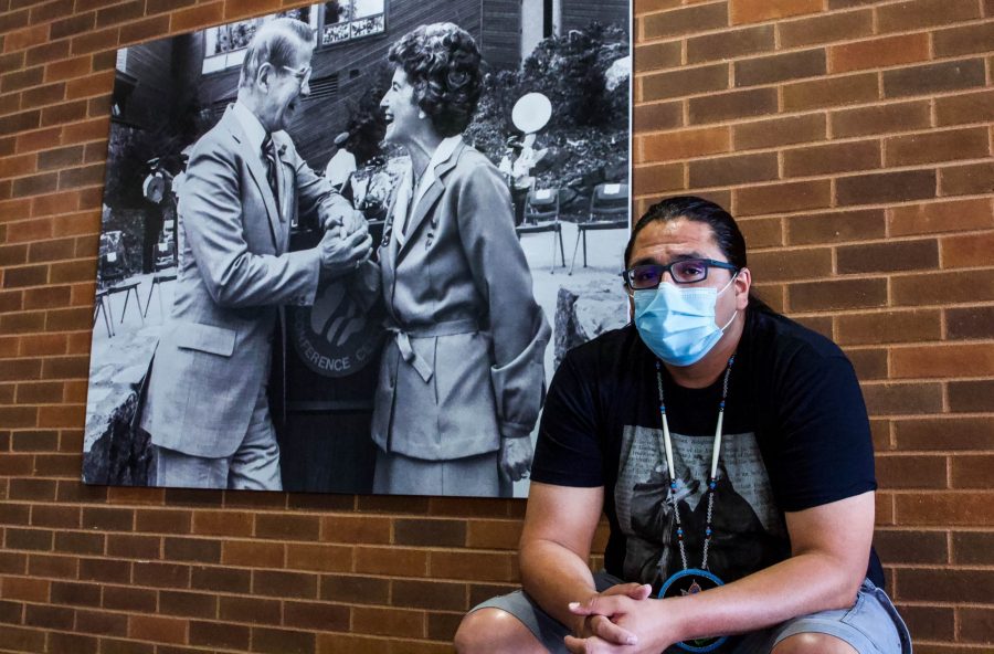 Benjamin Yawakie, president of the Humphrey Students of Color Association, sits in front of a photo of Orville and Jane Freeman in the Humphrey School of Public Affairs on Wednesday, July 22 at the University of Minnesota, Twin Cities campus. The Freeman Commons, to Yawakie’s left, is one of the spaces on campus associated with the Freemans that the group wants to rename.