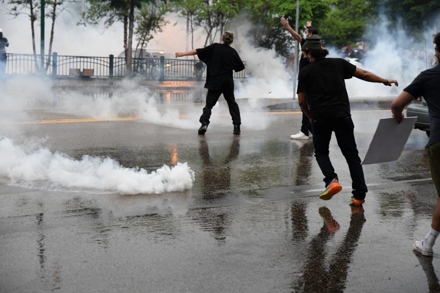 Protesters dodge tear gas cannisters outside of the Minneapolis 3rd Police Precinct on Tuesday, May 26. 