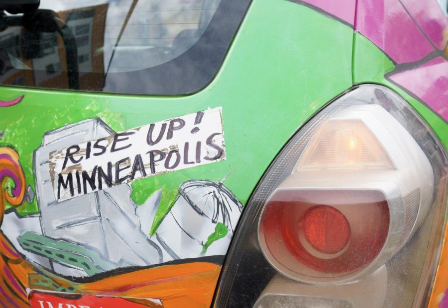 A car painted with pro-voting messages is prepared to be driven for the community bike ride. Cyclists and art car drivers made their way around Cedar Riverside on Saturday, Oct. 17 to build community and increase voter turnout.