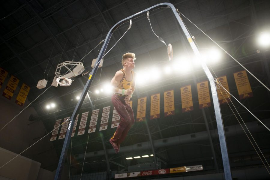 Junior Shane Wiskus performs on the rings during the meet against against the Fighting Illini at the Maturi Pavilion on Friday, Jan. 24.