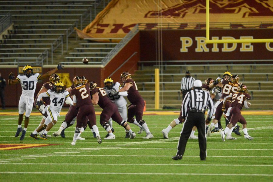 Gophers quarterback Tanner Morgan launches a pass over Michigans defensive line on Saturday, Oct. 24.