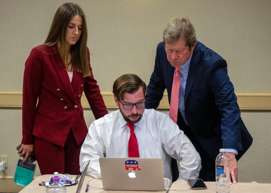 Jason Lewis, Republican candidate for U.S. Senate, checks in with his campaign team before delivering a speech at the GOP election event in Minneapolis on Tuesday, Nov. 3.