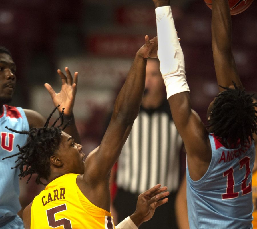 Guard Marcus Carr shoots through the opponents at Williams Arena on Wednesday, Nov. 28.