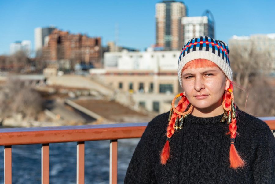 Activist and Giniw Collective member Wabigonikwe Raven poses for a portrait in front of St. Anthony Falls on Saturday, Nov. 28. The Giniw Collective is an Indigenous women, 2-Spirit led group that is an active part of the StopLine3 movement.