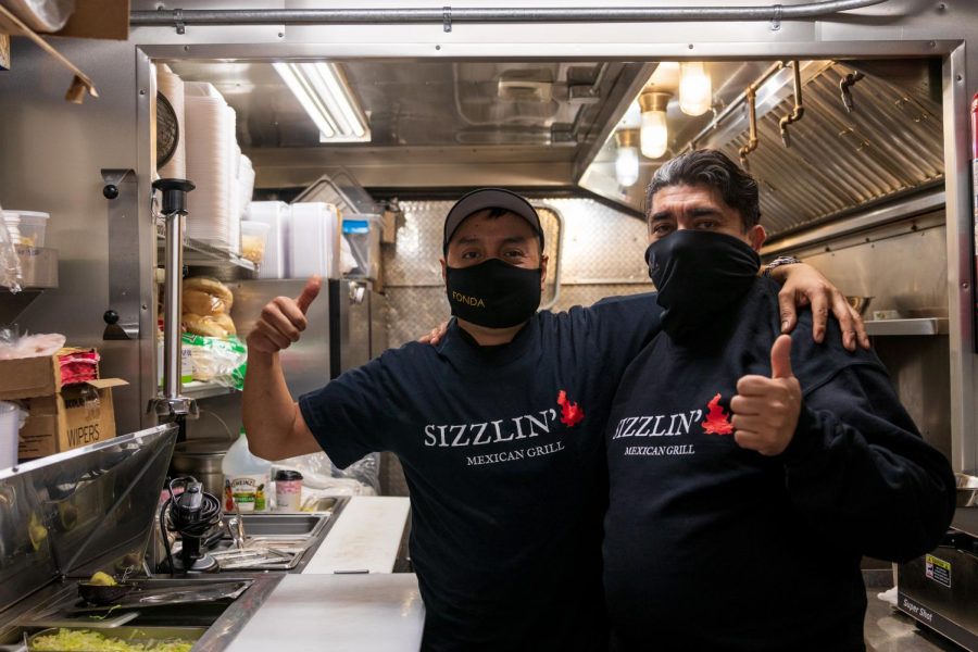 Co-owners Roberto Quiros, left, and Jesus Hernandez pose for a portrait in their new food truck, Sizzlin’ Mexican Grill, on Monday, Dec. 7. “We make all the ingredients fresh every day,” said Hernandez.