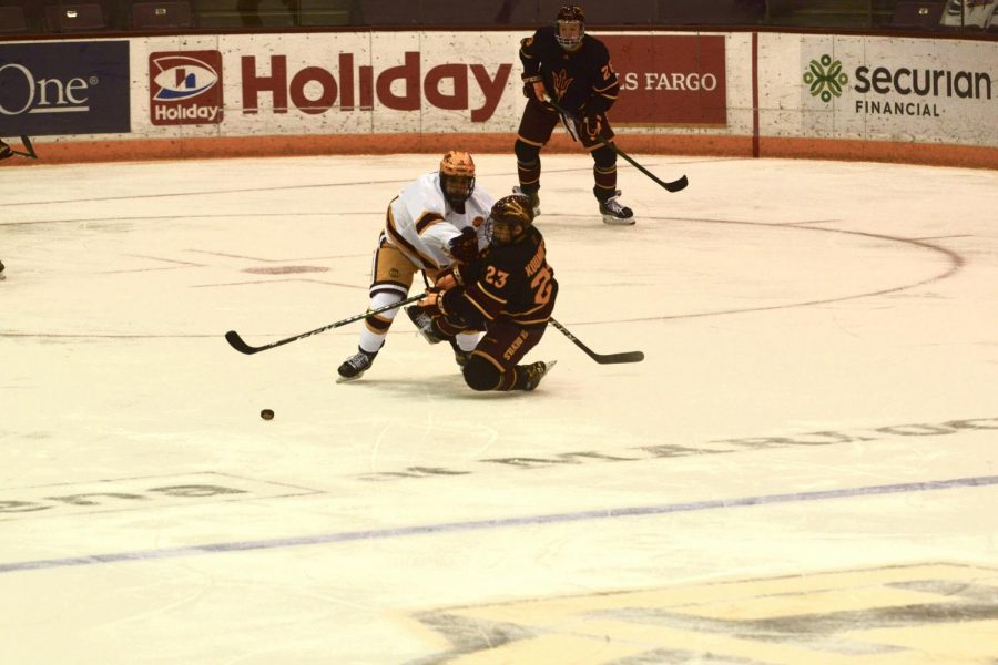 Forward Nathan Burke blocks Arizona States Justin Robbins from reaching the puck in 3M Arena on Friday, Jan. 22. The Gophers beat Arizona State with a final score of 10-2.
