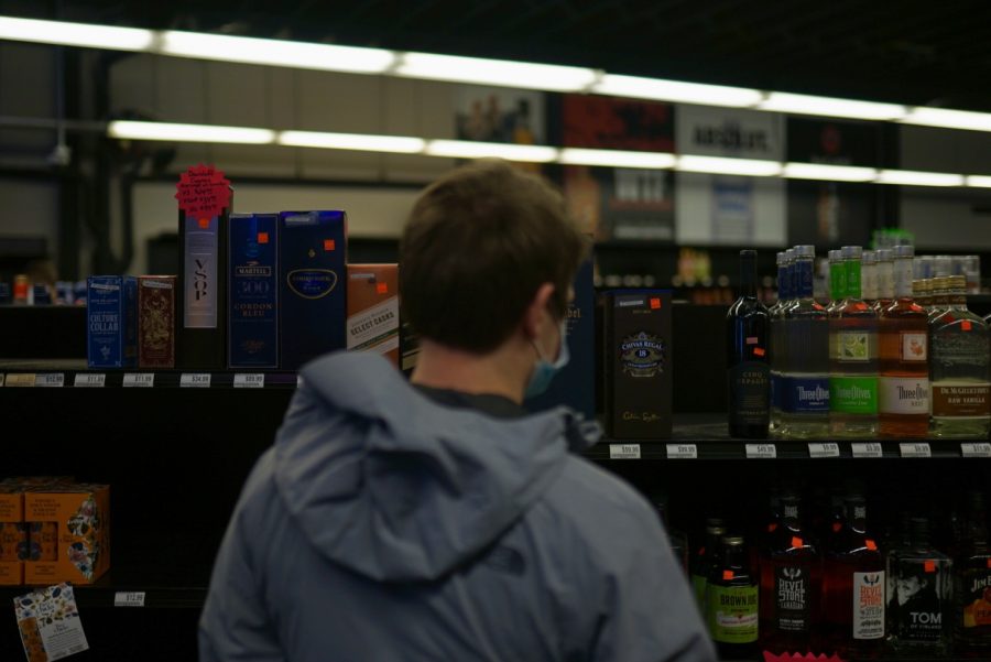 Jake, a former student at the University of Minnesota, shops around one last time in the Dinkytown Wine and Spirits on Saturday, Jan. 9. “This is crazy that this is the last time I will be in here.”