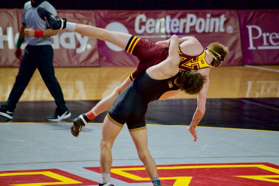 An Iowa State wrestler takes down Gopher Wrestler Boo Dryden at Maturi Pavilion on Friday, Jan. 22. The Gophers lost with a final score of 35-4.
