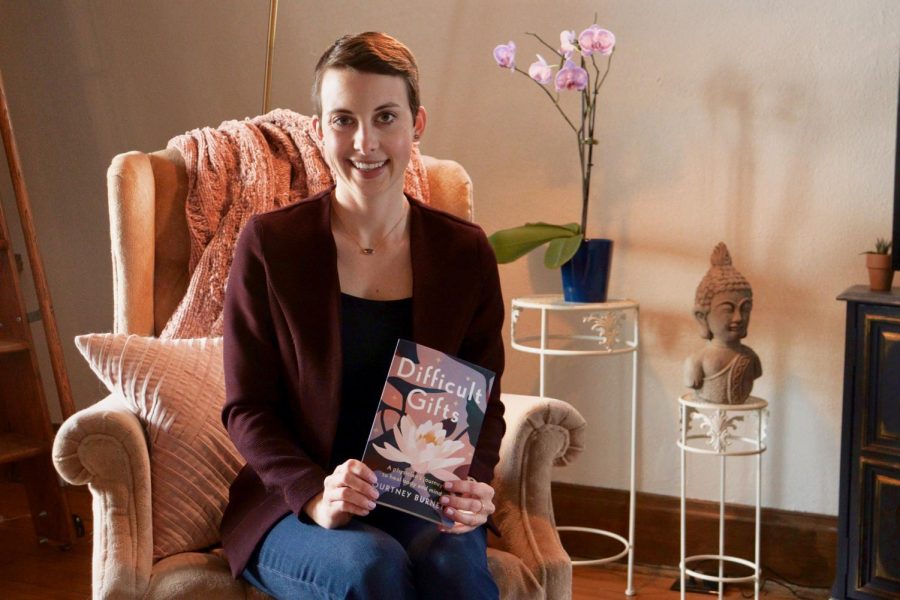 Physician and author Courtney Burnett poses with her memoir Difficult Gifts in her home in St. Paul on Friday, Feb. 5. In the memoir, to be released on Feb. 8, Burnett describes searching for happiness when she unexpectedly finds herself diagnosed with a malignant brain cancer.