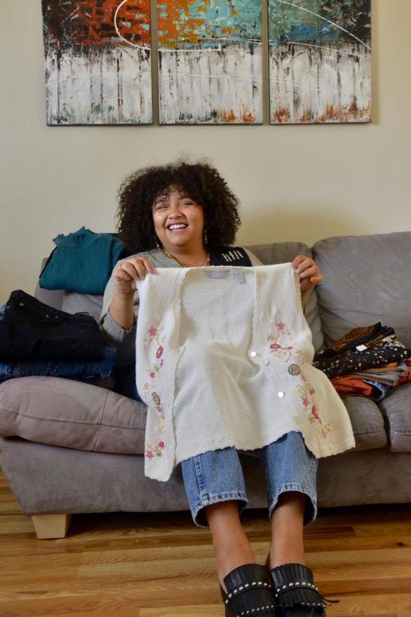 Olivia Anzior poses for a portrait with vintage clothes from her shop, Doowop Vintage, in her Minneapolis apartment on Sunday, March 22. Anzior opened the Instagram shop in the early months of the pandemic.