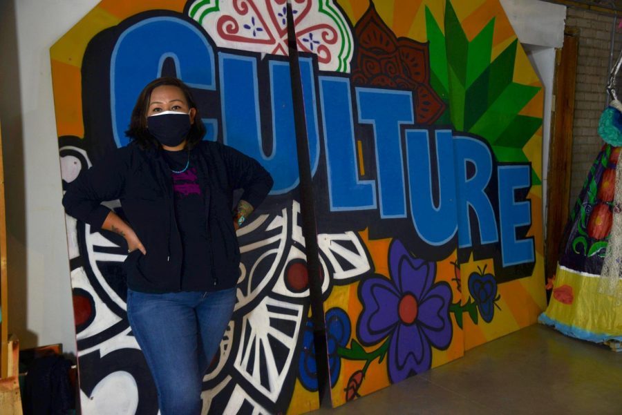 Thomasina Topbear poses for a portrait in front of her mural in the Indigenous Roots Cultural Arts Center in St. Paul on Monday, March 15. Topbear is a part of City Mischief Murals, a BIPOC artist collective that plans and creates murals in the Twin Cities area.