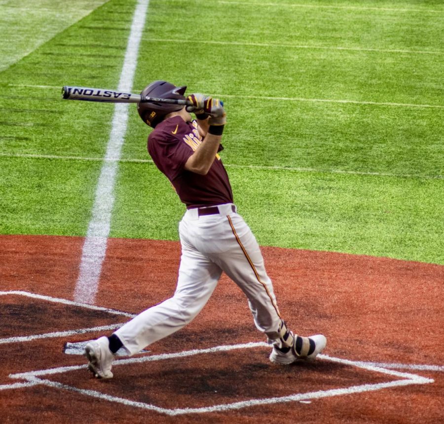 Gopher Batter Jack Wassel follows through his swing in U.S. Bank Stadium on Sunday, March 7. The Gophers lost to Indiana, 8-1.