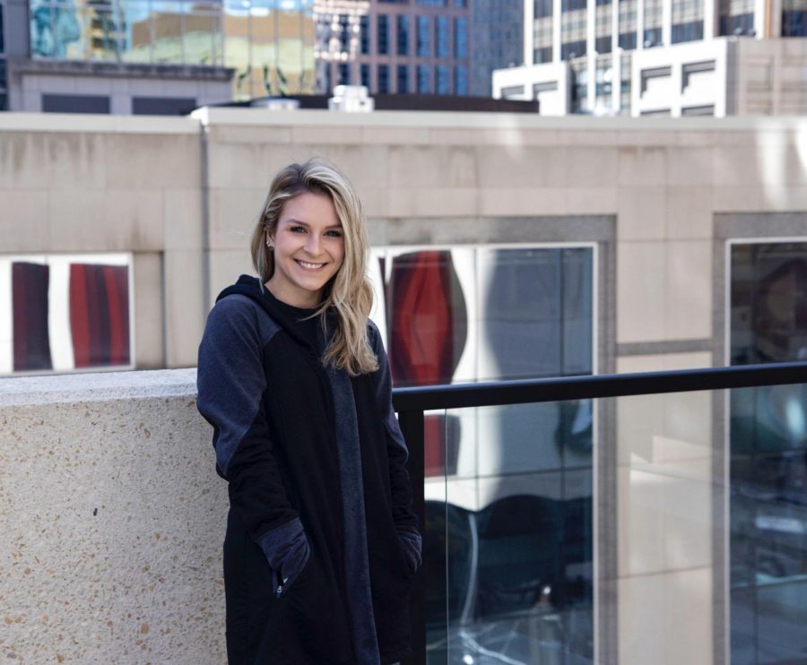 University of Minnesota alum Elise Eckert poses for a portrait on a balcony in downtown Minneapolis on Tuesday, March 30. Eckert, who graduated in Spring 2020, filed independently on her 2020 taxes for the first time, prompted by the opportunity to receive a stimulus check.