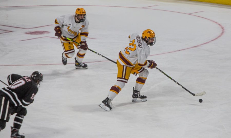 Gophers forward Bryce Brodzinski moves the puck away from the Gophers goal at the
Budweiser Events Center in Loveland, Colorado on March 27, 2021 .The Gophers defeated the
University of Nebraska Omaha Mavericks, 7-2.