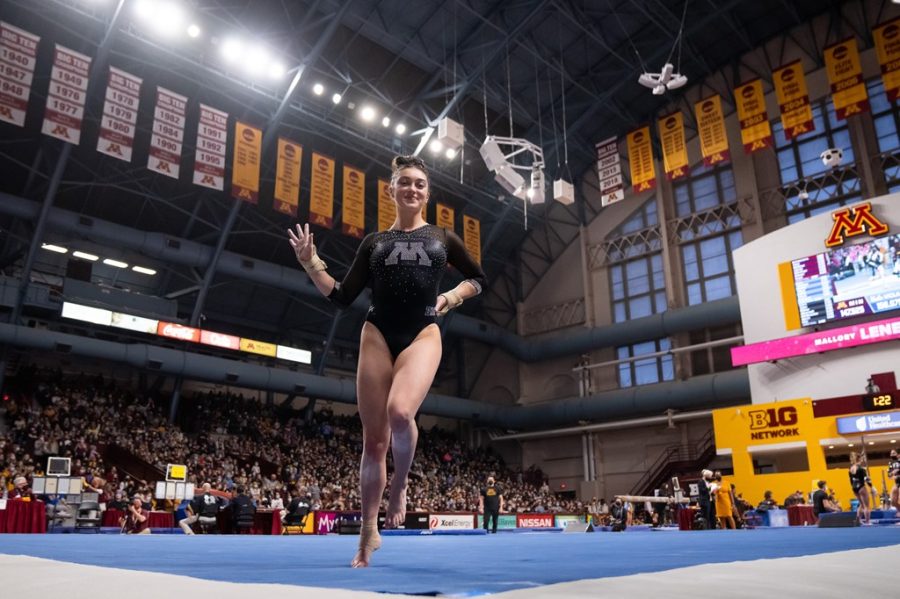 Junior Mallory LeNeave throws up a peace sign on floor in front of a packed Maturi Pavilion during Minnesota’s season-opening victory over Iowa and UCLA on Monday, Jan. 17, 2021.