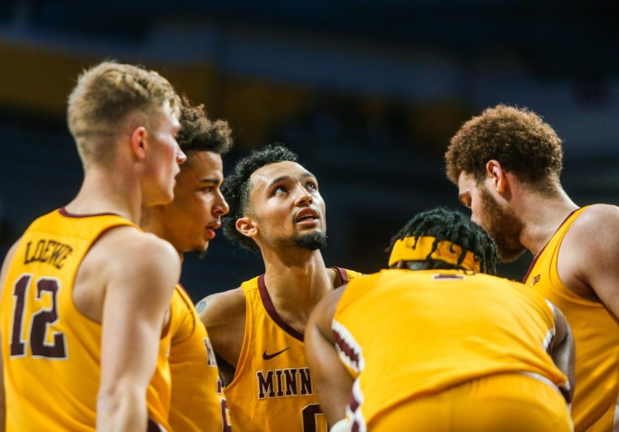 Senior Luke Loewe stands in a huddle with his teammates during a game against Texas A&M- Corpus Christi on Tuesday, Dec. 14, 2021 at Williams Arena in Minneapolis, Minn.