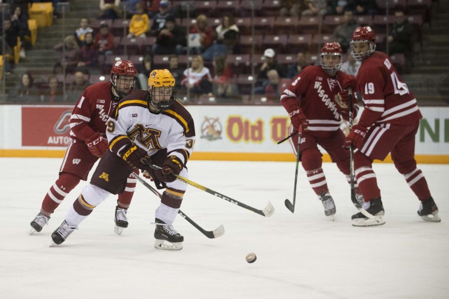 Ben Meyers battles for the puck in a game against the Wisconsin Badgers on Nov. 22, 2019 at 3M Arena at Mariucci in Minneapolis, Minn.