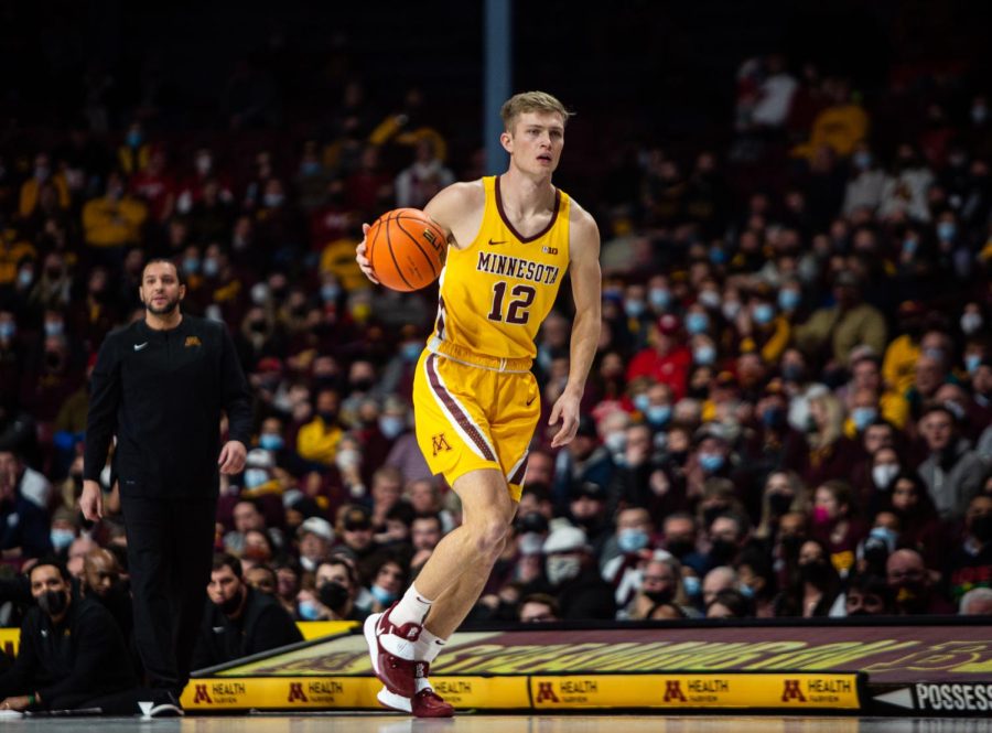 Luke Loewe dribbles down the court in a game against the University of Wisconsin Badgers on Feb. 23, 2022 at Williams Arena in Minneapolis, Minn.