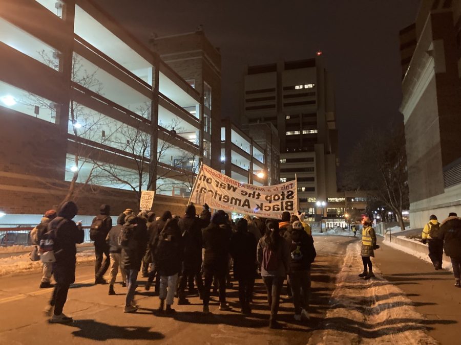 Protestors march down SE Beacon Street on Wednesday, Feb. 16. University of Minnesota students organized the protest in response to the police killing of Amir Locke.