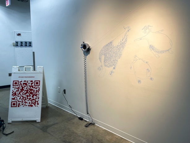 An+installation%2C+titled+Scribit%2C+at+the+Regis+Art+Center+on+Wednesday%2C+March+16.+Scribit+is+a+self+drawing+robot+that+draws+designs+that+are+uploaded+to+a+QR+code.