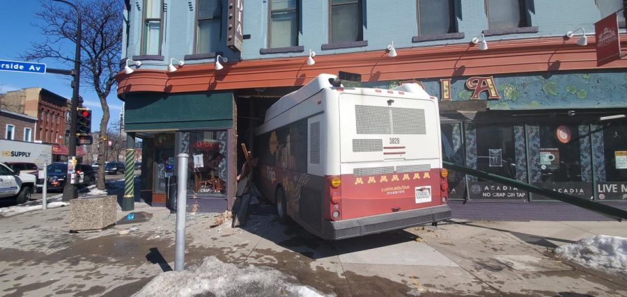 Photo of the University bus after it drove into Acadia Cafe located on located on the corner of Cedar Avenue and Riverside Avenue. Photo courtesy of KFAI A.M. Drive.