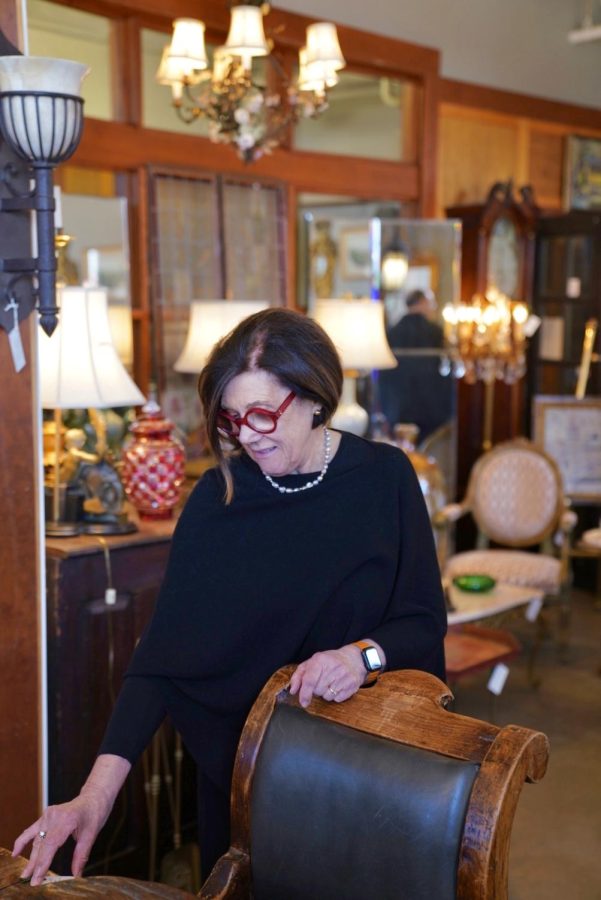 Claire Steyaert of Claire Steyaert Antiques adjusts items in her store on Saturday, March 12. Claire Steyaert Antiques had its Grand Reopening on Saturday after being open by appointment only since the start of COVID-19.