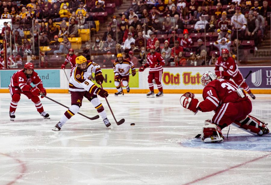 Captain Sammy Walker shoots the puck in a game against the Wisconsin Badgers on Saturday, Feb. 26, 2022. 