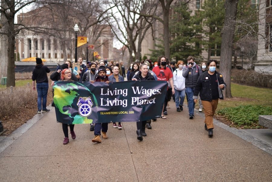 Students+and+protesters+march+toward+Northrop+on+Friday%2C+April+22.+The+protest%2C+planned+by+Teamsters+Local+320%2C+was+organized+to+bring+attention+to+the+low+wages+of+union+workers+and+custodial+staff+at+the+University.