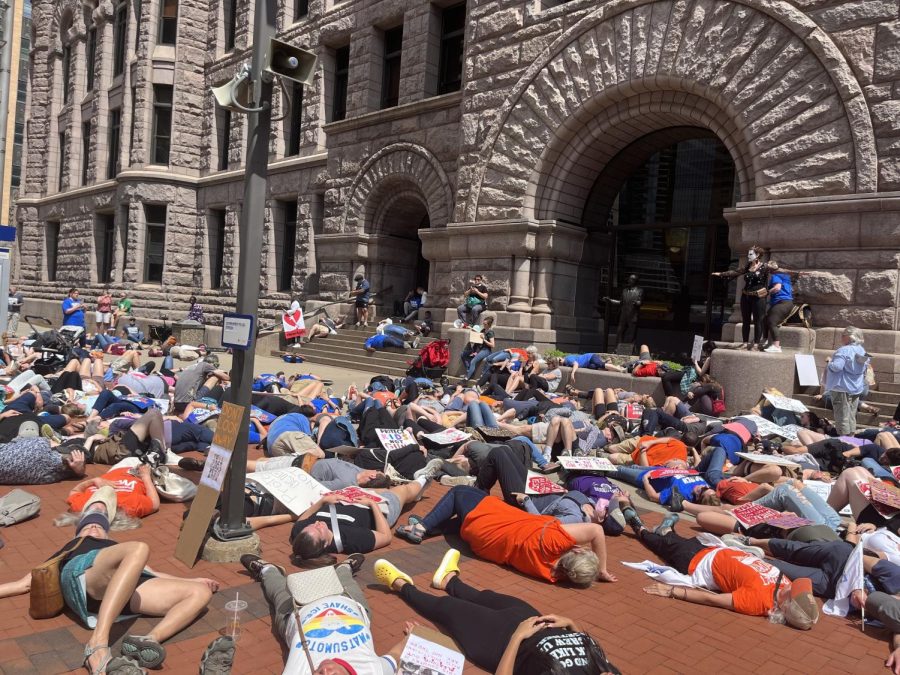 Protesters+laid+down+in+front+of+City+Hall+on+June+12+to+represent+students+participating+in+an+active+shooter+drill.+