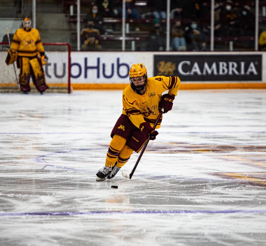 Forward Audrey Wethington drives the puck down the ice during Minnesotas game against St. Cloud, Feb. 11, 2022.