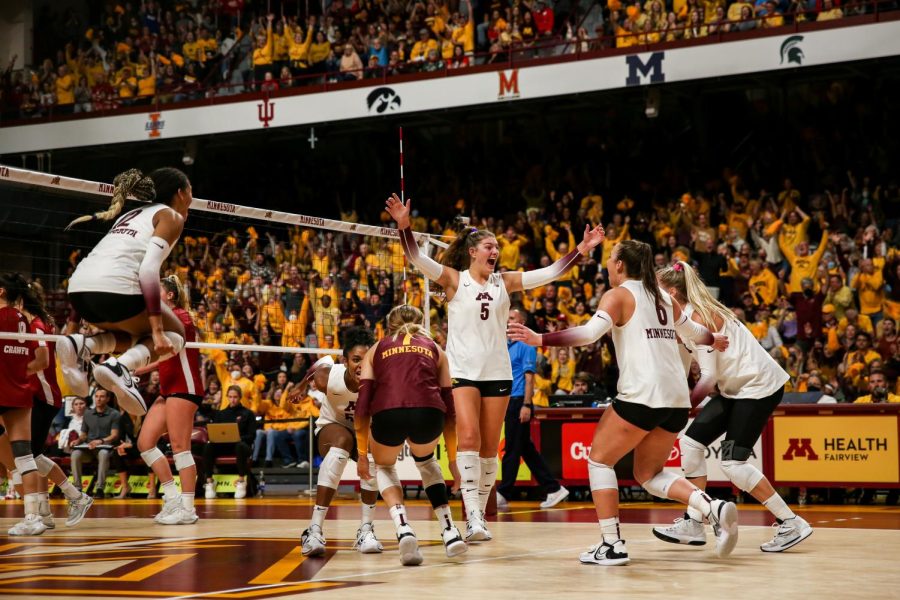 The Minnesota Volleyball Team celebrates a point in the teams victory against Wisconsin, Sept. 25.