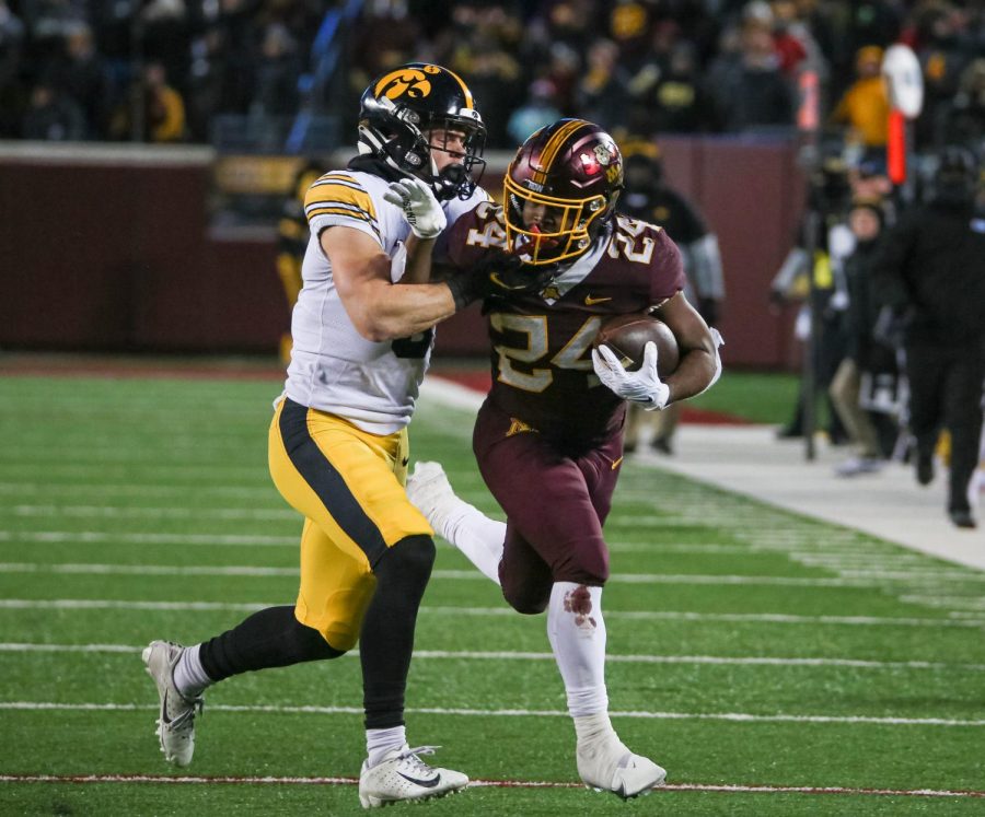 Running back Mohamed Ibrahim attempts to break free from an attempted tackle during Minnesotas game against Iowa, Saturday, Nov. 19. The Gophers lost to the Hawkeyes, 13-10.