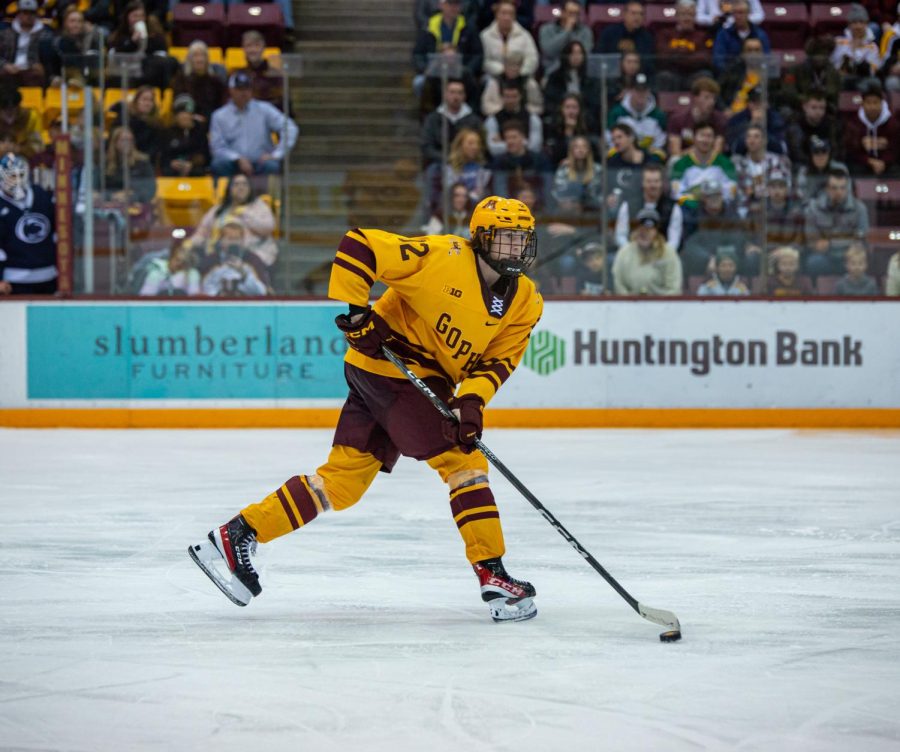Forward+Logan+Cooley+looks+to+pass+the+puck+during+the+Gophers+game+against+Penn+State%2C+Nov.+11.+