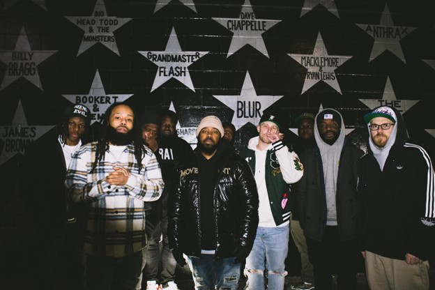 (from left to right) Reiki, Why Khaliq, Righteous Emcee, JuneThaKid, Juice Lord, Knucky, Ace P, PeaceGod, $aiku, and DJ Buster Bax outside of the 7th Street Entry for the “Things I Can’t Speak About” release showcase.  Photo credit and courtesy of Bryant Slack @msphiphop. 