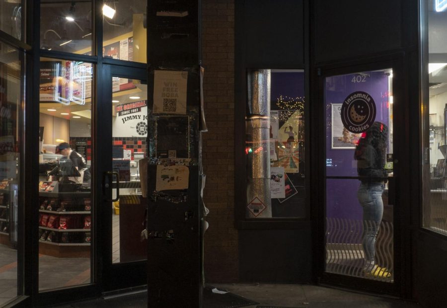 10:05 p.m. Students wait inside Jimmy Johns and Insomnia Cookies in Dinkytown for late-night food.