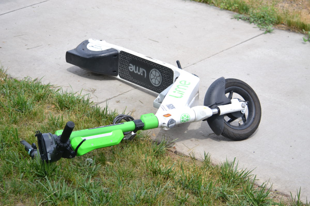 A Lime scooter tipped over on the sidewalk in Minneapolis, MN, on June 25, 2023.