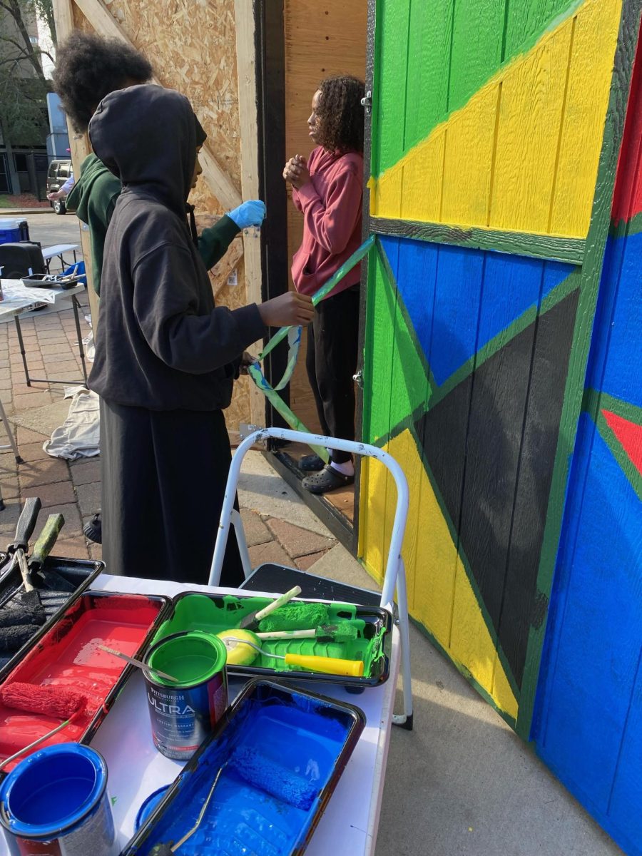 Kids paint the Plaza Shed in Cedar-Riverside. (2023)