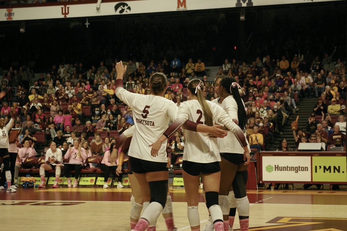 Gophers volleyball huddles together during a match against Rutgers on Oct. 20, 2023