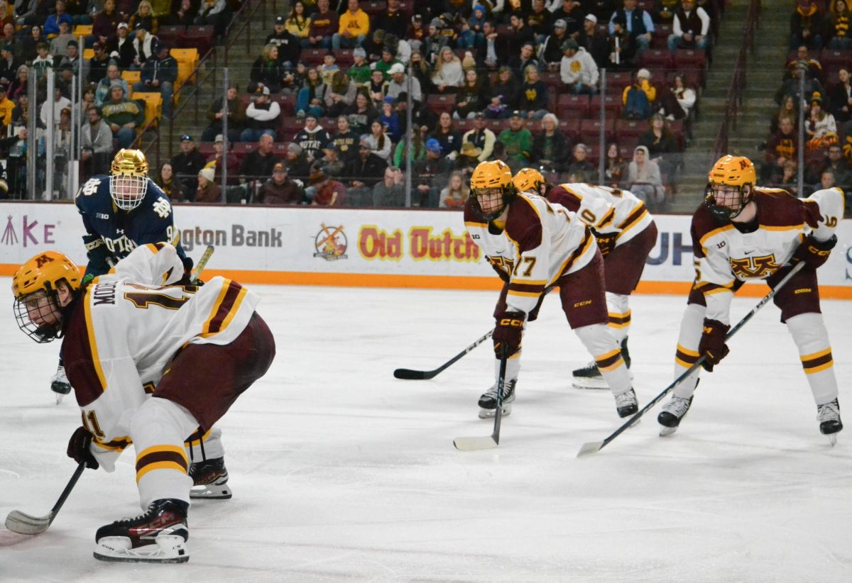 Rhett Pitlick (No. 77) waits for the puck to drop on Nov. 18, 2023. The Gophers beat Notre Dame 4-1 at Mariucci Arena.