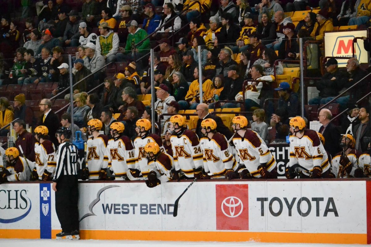 The players watch the game from the bench on Saturday, Nov. 18, 2023. The Gophers played Notre Dame and won 4-1