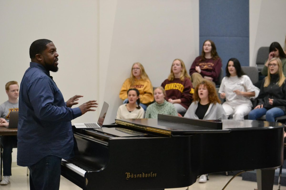 Adrian Davis, the director of gospel choir, listens to his students singing on Tuesday, Feb. 20, 2024. Davis works to teach students the message behind the music and why it is important.