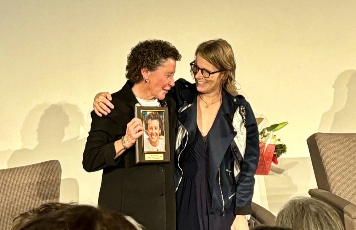 Mary Jo Kane and Nicole LaVoi embrace each other in a bittersweet moment of gratitude at a lecture series on Feb. 6 celebrating the 30th anniversary of the Tucker Center.