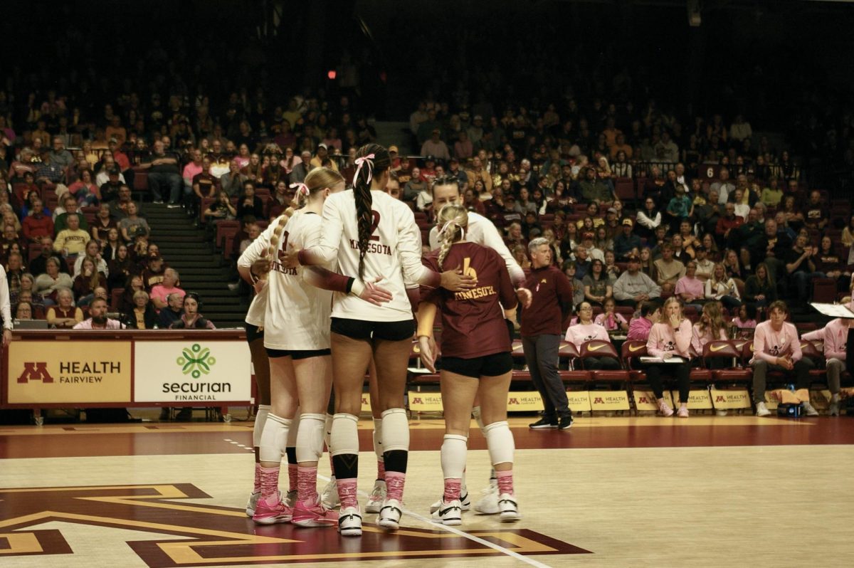 Gophers volleyball huddles together during a match against Rutgers on Oct. 20, 2023.