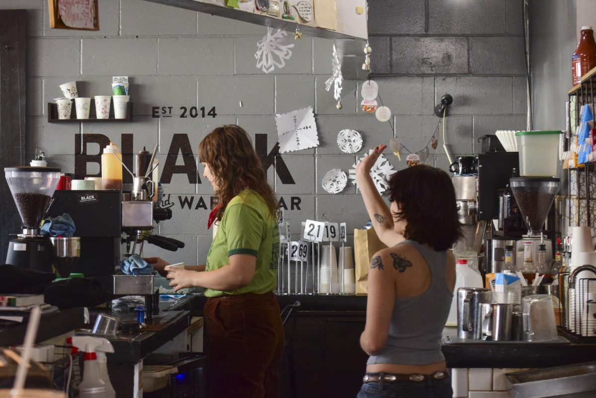 On their last day, a staff member bids farewell to a customer. Black Coffee and Waffle Bar, located on Como Avenue and 15th Avenue SE, shut its doors on March 17th before a renovation and a reopening as a new coffee shop called Vitality. 