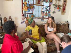 From left to right, Yolanda Hester, a public historian, speaks to Margarita Montalvo, a renowned Cuban sculptor, with second-year student Liliane Sojos-Ortiz listening on the right.