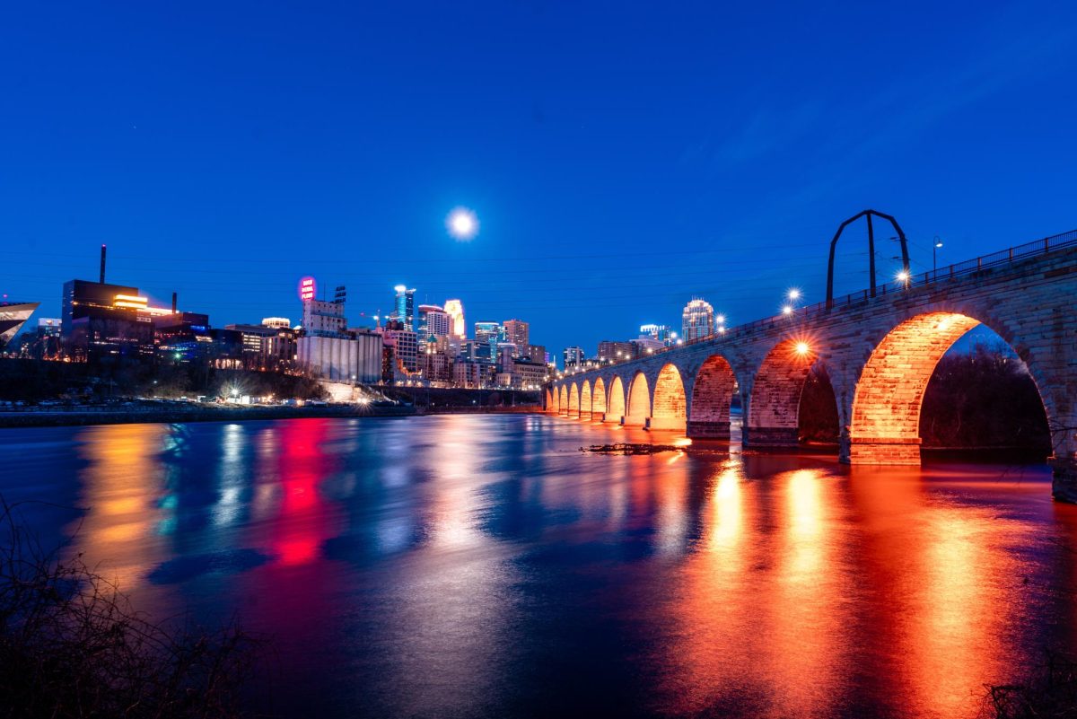 The moon rises over the Stone Arch bridge in the early morning on March 28. Many students and student groups, such as the University of Minnesota Astro Club, are planning to watch the partial solar eclipse that will reach its peak for Minneapolis viewers at 2:02 p.m. on Monday.