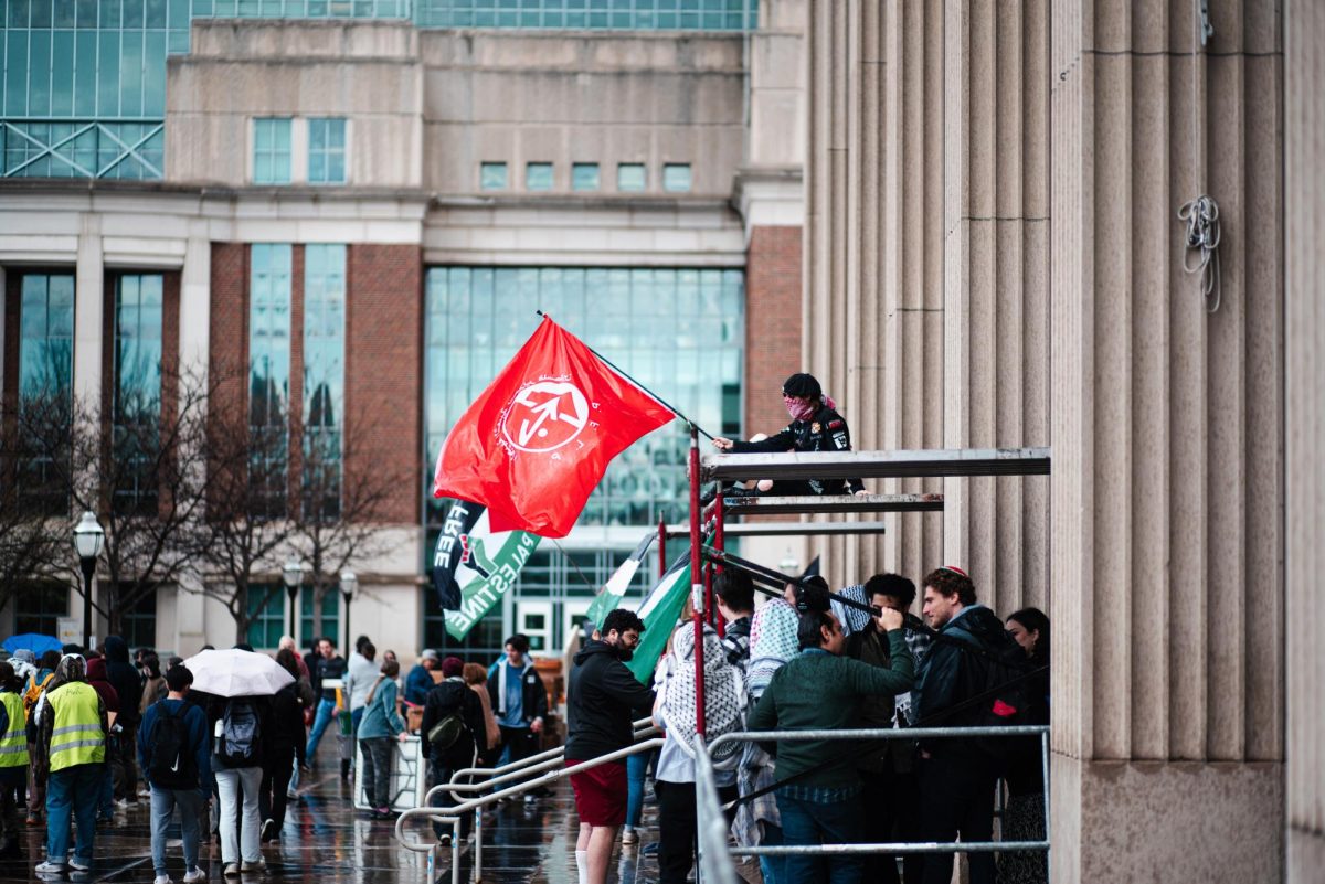 Student demonstrators in the rainy weather protesting outside of Coffman Memorial Union on Tuesday.